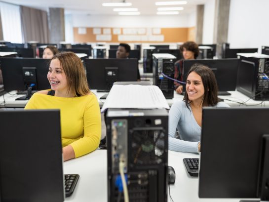 Young students listening a lecture inside university classroom